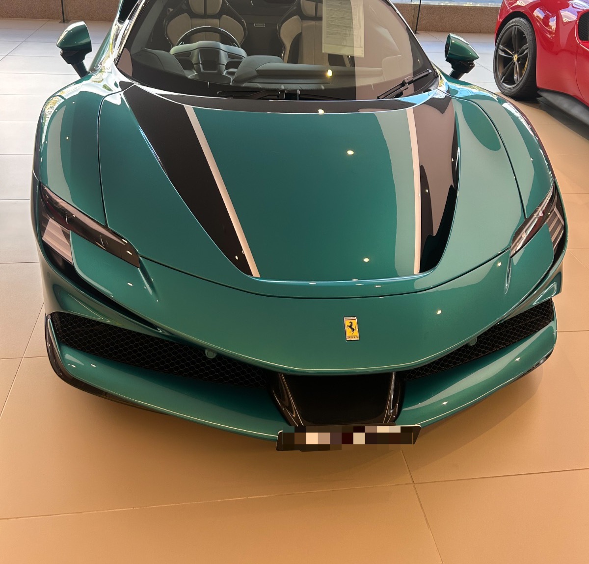 A Ferrari SF90 Spider in Verde, photographed by us at Ferrari Sydney. Photography: Queen of Cars; number plate blurred per our privacy policy.