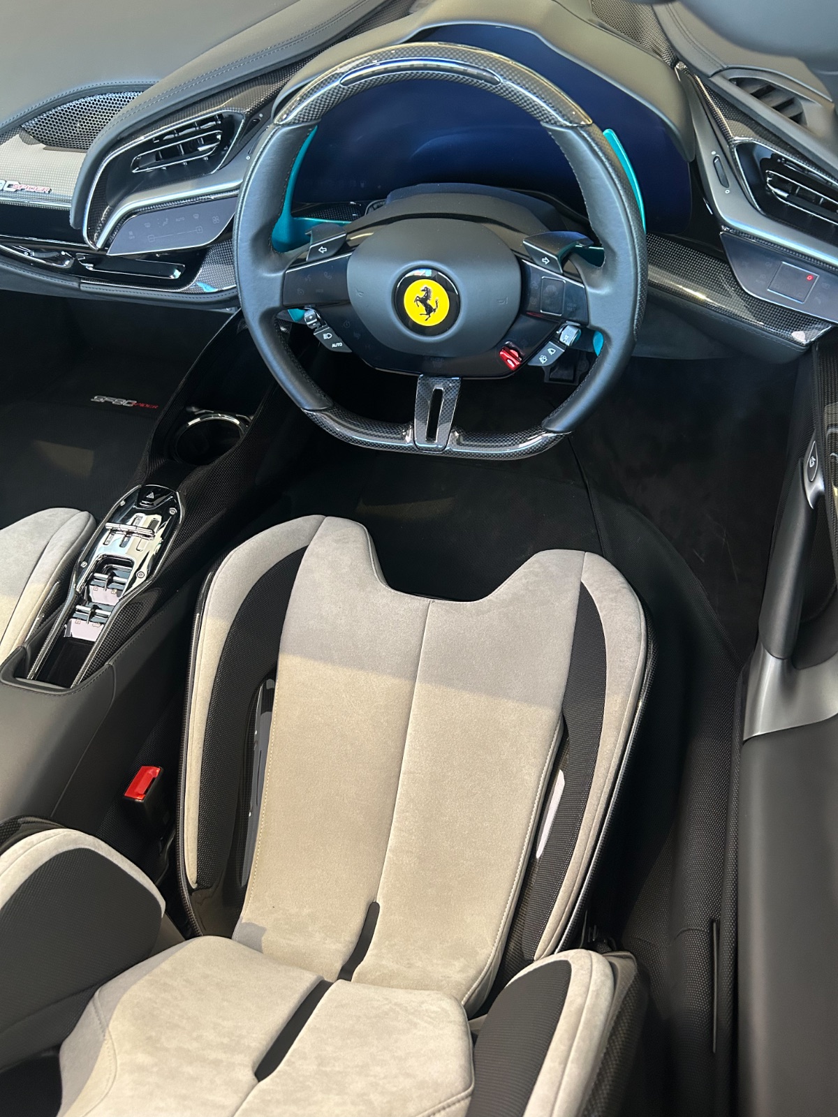 The cabin: carbon-fibre wheel, ivory Alcantara, and a start button that means it. Photography: Queen of Cars.